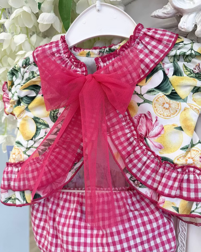 Babine Lemon Blossom Swing Back Dress & Pants featuring a lemon and pink floral print, open swing back, large tulle bow, frill collar, and matching pink gingham pants.