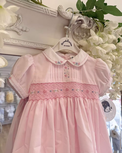 Sarah Louise Blair Pink Smock Dress featuring hand-smocked embroidery, pintuck detailing, embroidered Peter Pan collar, full skirt and bow back.