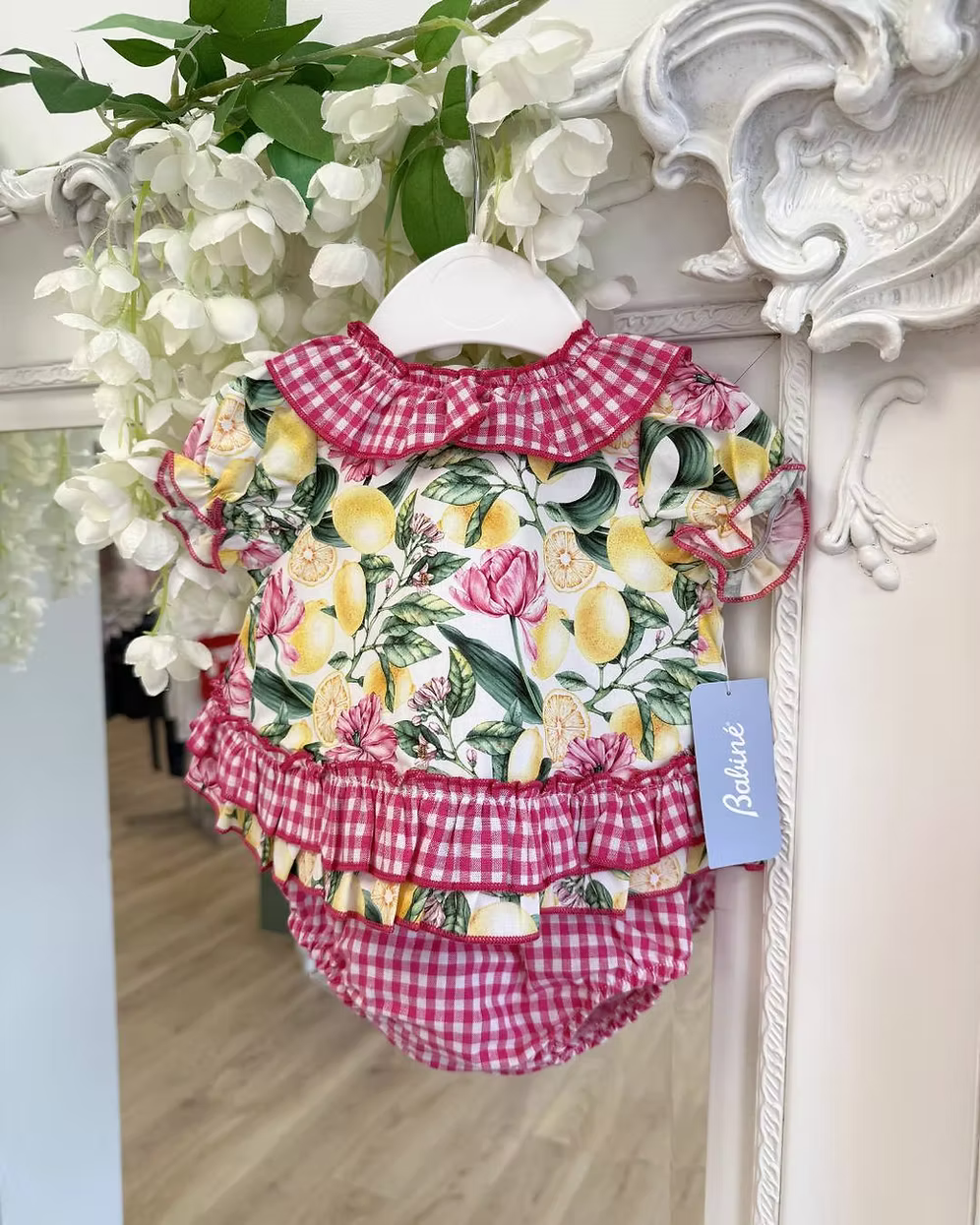 Babine Lemon Blossom Swing Back Dress & Pants featuring a lemon and pink floral print, open swing back, large tulle bow, frill collar, and matching pink gingham pants.