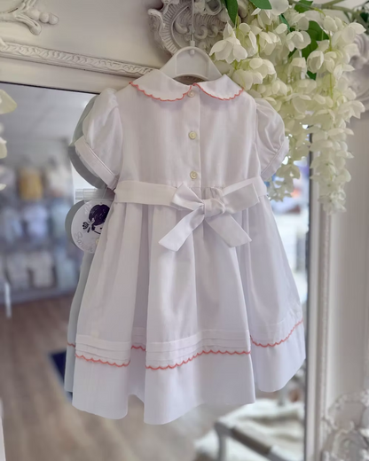 back of white dress with button and bow back fastening