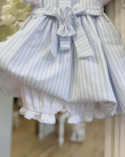 Pretty Originals Olivia Stripe Dress featuring blue and white stripes, hand-smocked rainbow embroidery, puff sleeves, matching bloomers and headband.