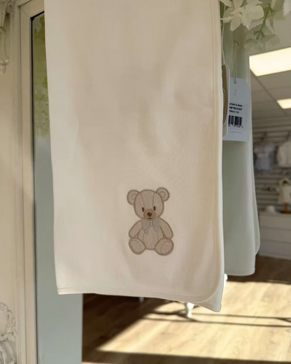 Baby Gi Teddy Shawl featuring soft cotton fabric, embroidered teddy bear detail and available in ivory, pink and blue colourways.