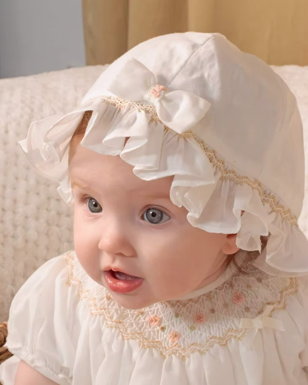 Sarah Louise x Little Lambs Heritage Ruffle Hat featuring soft ivory fabric, delicate ruffle trim and subtle embroidered detailing.