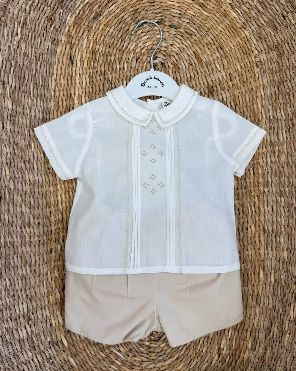 Sarah Louise x Little Lambs Heritage Boys Short Set featuring an ivory shirt with traditional detailing and tailored beige shorts.