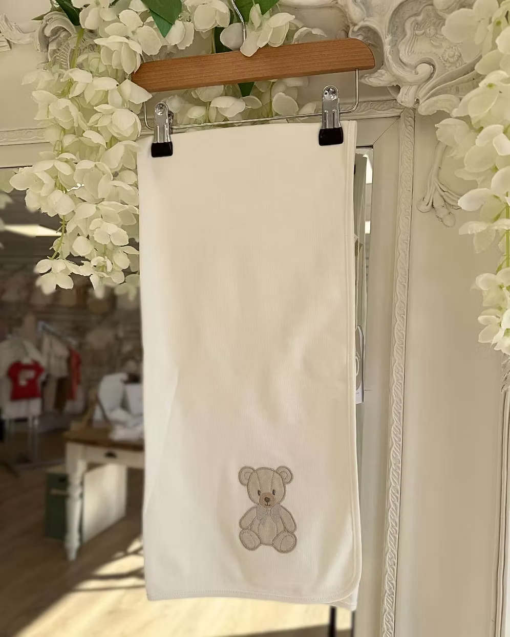 Baby Gi Teddy Shawl featuring soft cotton fabric, embroidered teddy bear detail and available in ivory, pink and blue colourways.