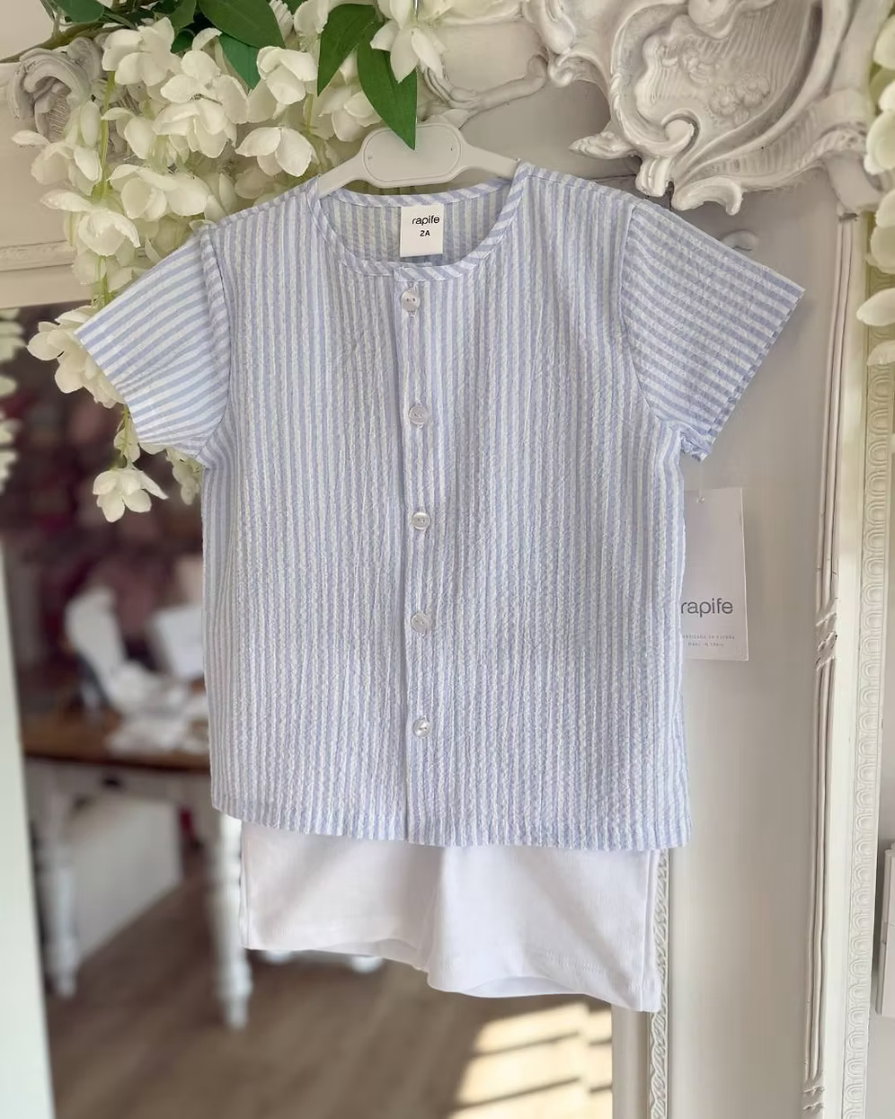 Blue and white striped shirt with white shorts