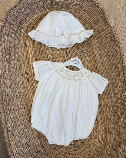 Sarah Louise x Little Lambs Heritage Bubble Romper featuring ivory fabric, hand-smocked floral embroidery, puff sleeves and a classic bubble shape.