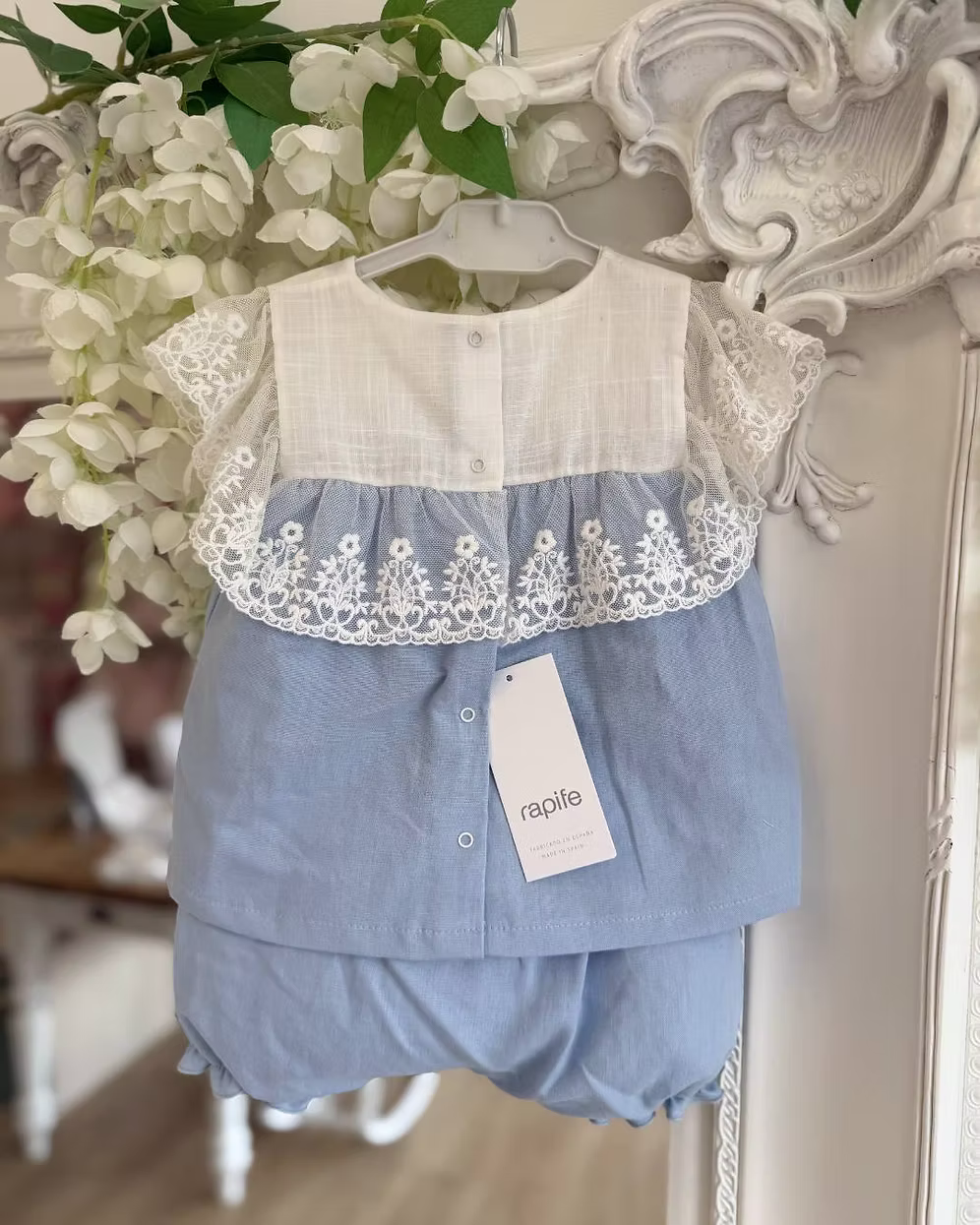 blue top and short with a white chest and white lace trim