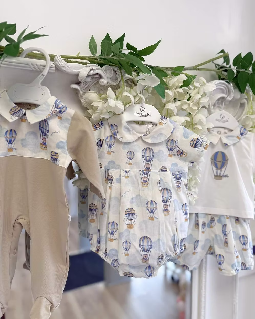 Deolinda Air Balloon Babygrow featuring a hot air balloon and bear print, neutral lower half, Peter Pan collar and popper fastening.