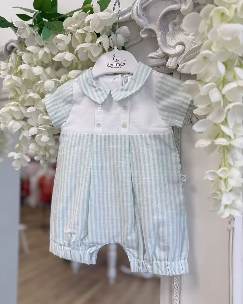 Deolinda Mint Stripe Romper featuring pastel mint stripes, a white chest panel, pointed collar, button detailing and a classic summer design.