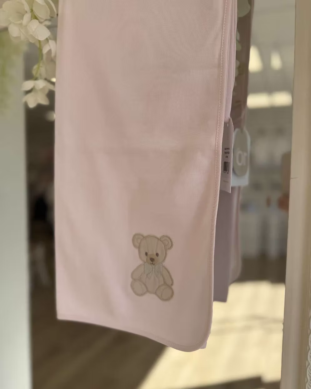 Baby Gi Teddy Shawl featuring soft cotton fabric, embroidered teddy bear detail and available in ivory, pink and blue colourways.