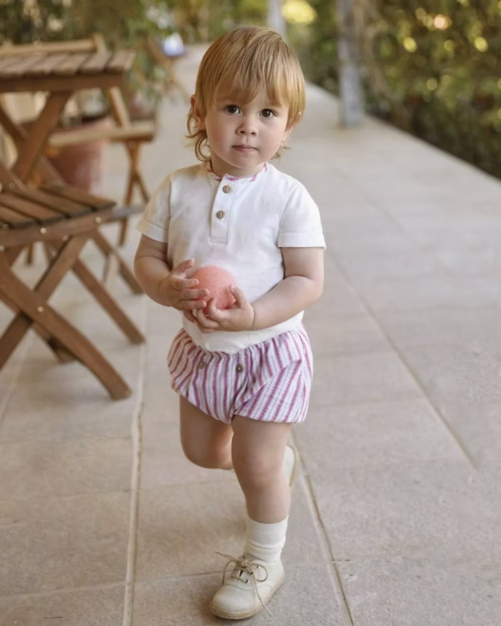 Designed with a linen-look striped short in a mix of red, blue, camel and soft off-white tones. Paired with a crisp white tee, finished with a contrasting striped trim to the neckline and classic wooden button detailing.