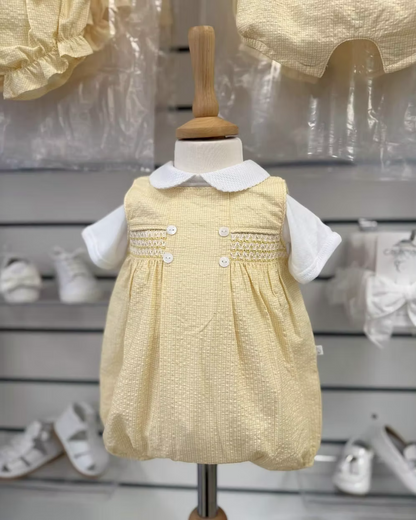 Deolinda Bumble Romper featuring buttery yellow gingham, a smocked chest panel, pleat detailing, button accents and a classic unisex design.