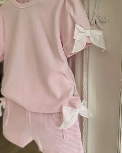 Bluesbaby Pia Pink Bow Short Set featuring a soft pink cotton top with puff sleeves, waffle shorts and contrasting white bow details.