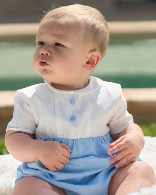 baby romper with white top half and blue bottom and blue buttons on the chest