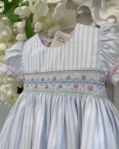 Pretty Originals Olivia Stripe Dress featuring blue and white stripes, hand-smocked rainbow embroidery, puff sleeves, matching bloomers and headband.