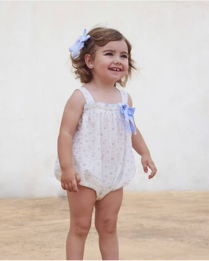 Blue Flower Romper. Designed in a soft white crinkle-textured fabric, this delicate piece is adorned with dainty blue floral detailing